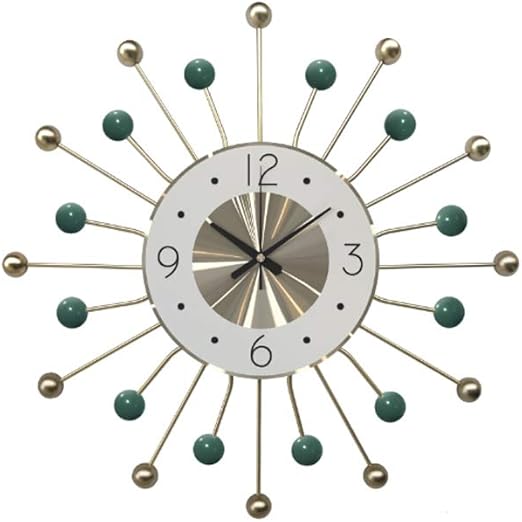 Decorative wall clock with sunburst design and green accents on a white background