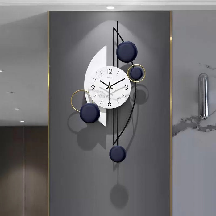 Modern big wall clock with decorative elements on a gray wall