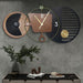 Modern wall clock with decorative elements on a gray wall