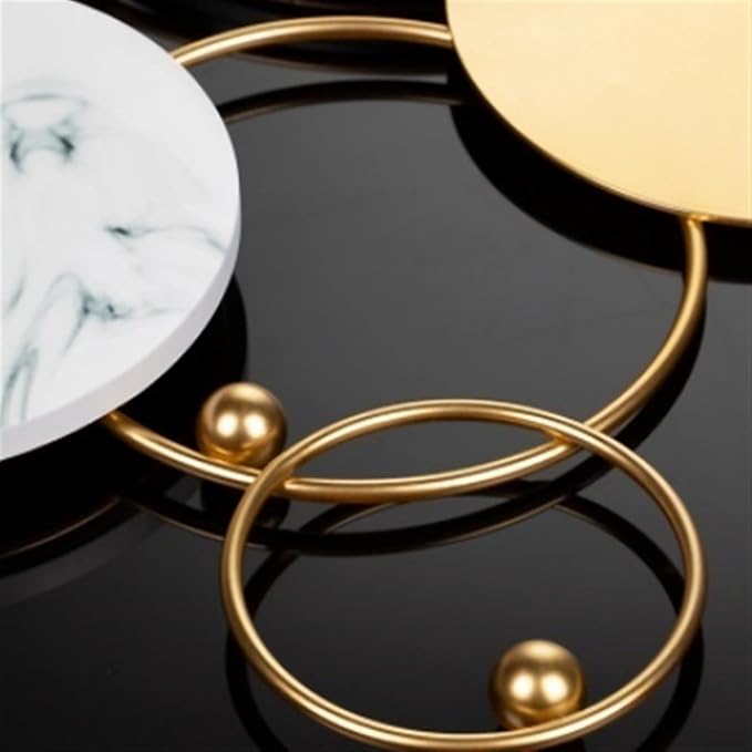 Gold bracelets on a dark surface with marble pattern