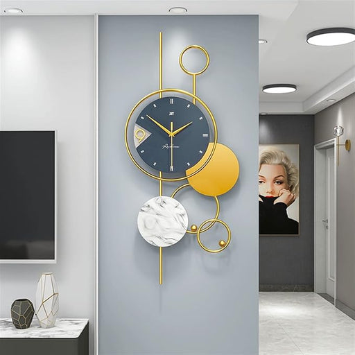 Decorative wall clock with gold and black design in a modern interior setting.