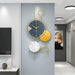 Decorative wall clock with gold and black design in a modern interior setting.