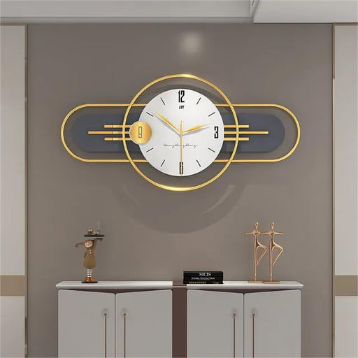 Decorative wall clock with gold frame and white face on a gray wall.