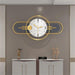 Decorative wall clock with gold frame and white face on a gray wall.