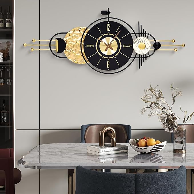 Decorative wall clock with gold and black design on a wall above a dining table.