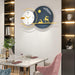 Modern wall clock with decorative elements on a dining room wall