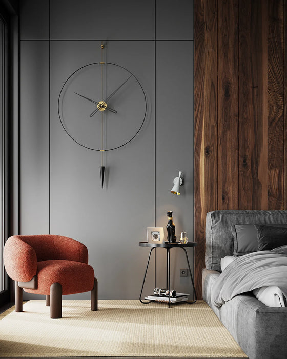 Modern living room with a red armchair, gray sofa, and decorative clock on a gray wall.