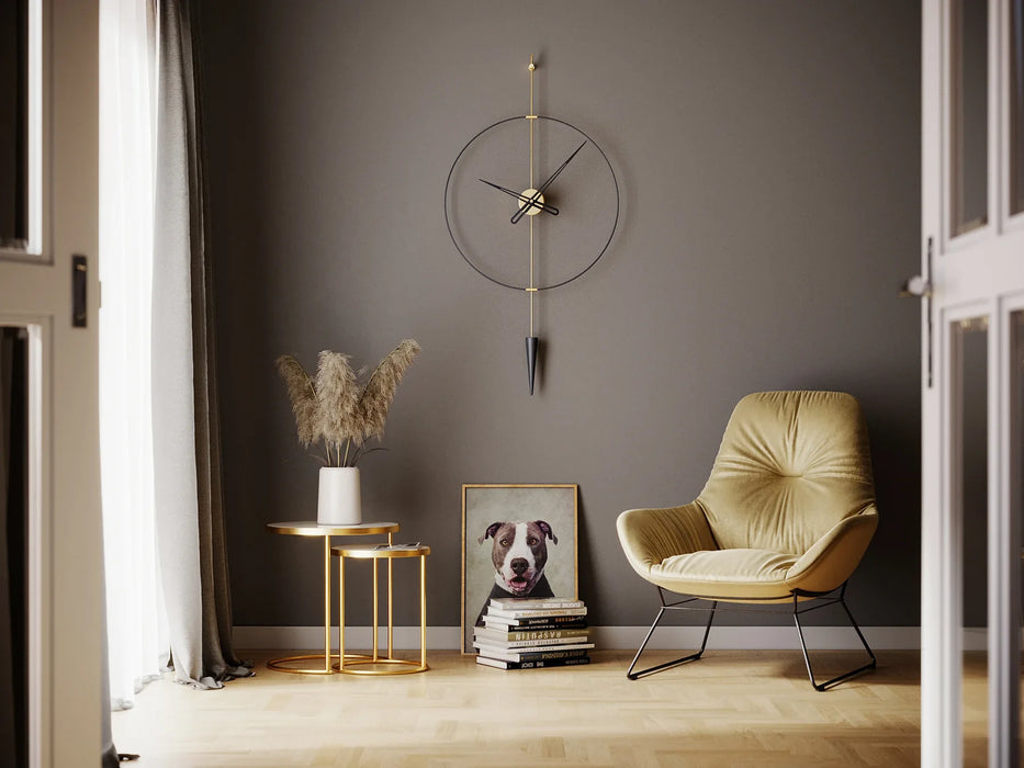 Modern interior with a beige armchair, gold side table, and decorative items against a gray wall.