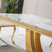 Dining table with marble top and gold legs in a room setting
