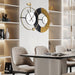 Modern wall clock with gold and black design in a dining room setting