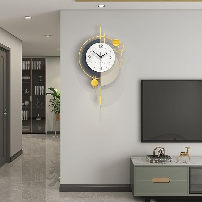 Modern wall clock with gold accents on a gray wall in a living room setting.