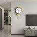 Modern wall clock with gold accents on a gray wall in a living room setting.