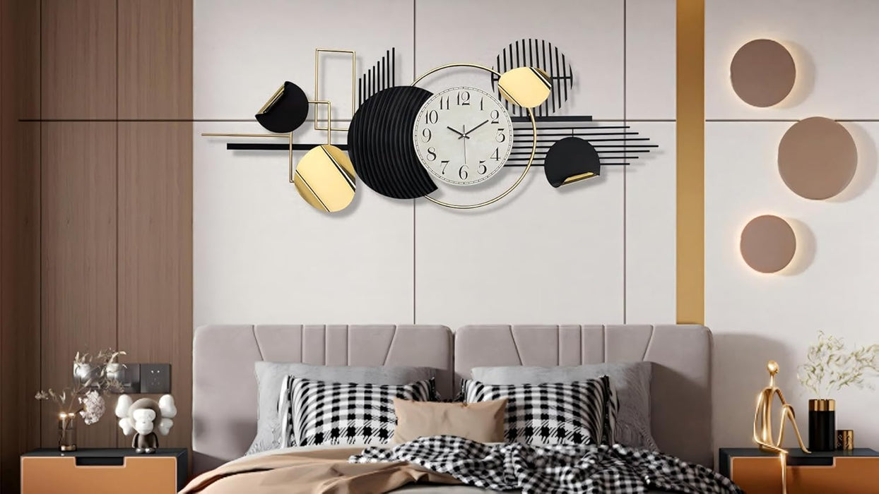 Decorative wall clock with abstract design on a wall above a bed.