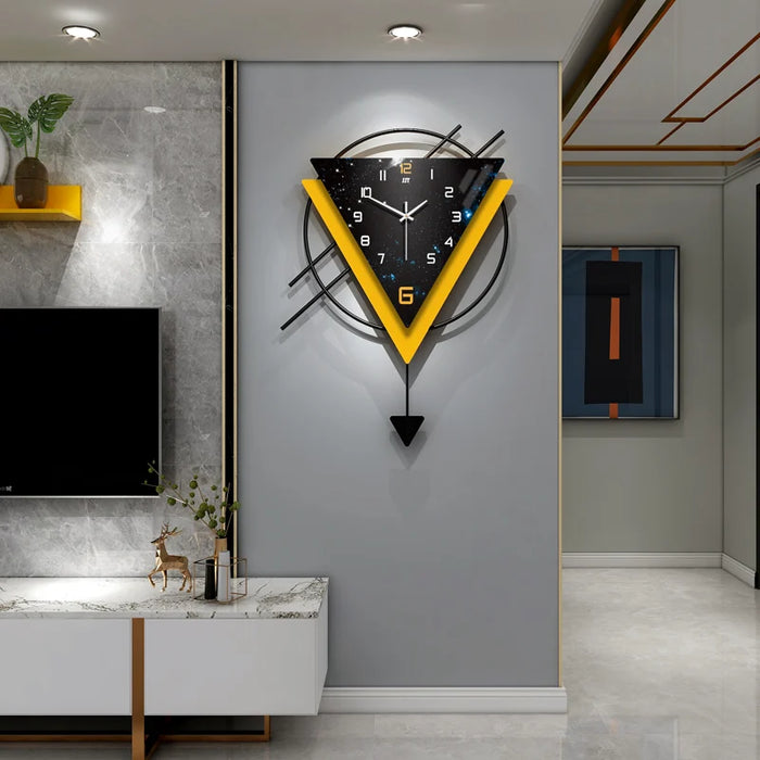 Modern wall clock with geometric design on a gray wall in a stylish interior setting.