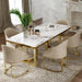Dining room with marble table and gold legs, surrounded by beige chairs.