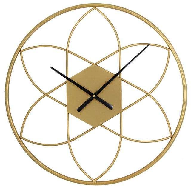 Gold geometric wall clock with black hands on a white background