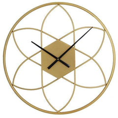 Gold geometric wall clock with black hands on a white background