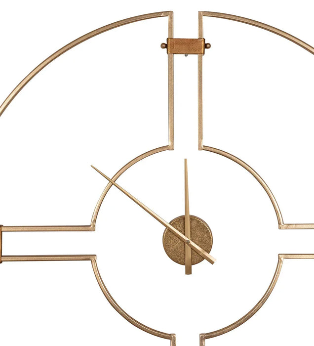 Gold wall clock with geometric design on a white background
