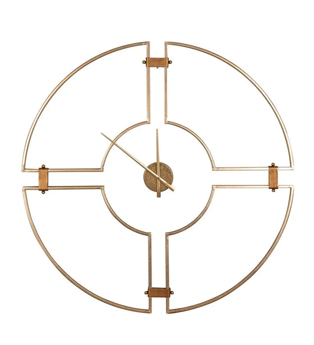 Gold metal wall clock with geometric design on a white background